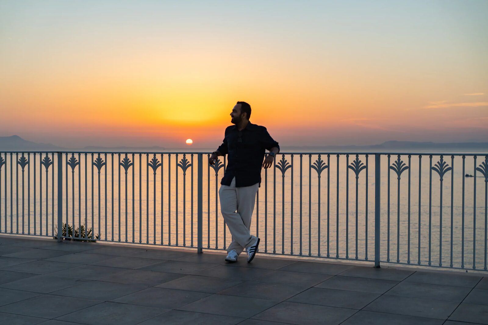 Traveler watching the coastal sunset
