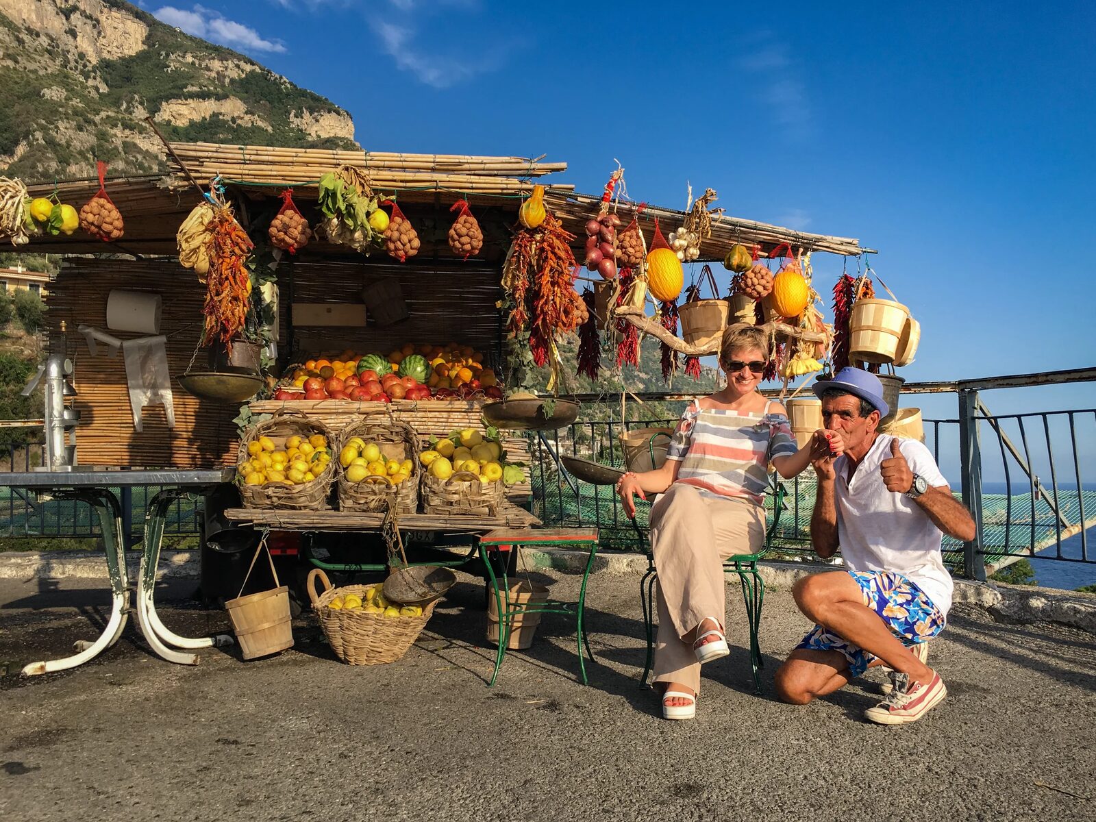 Travelers at a colorful mountain lemon stand